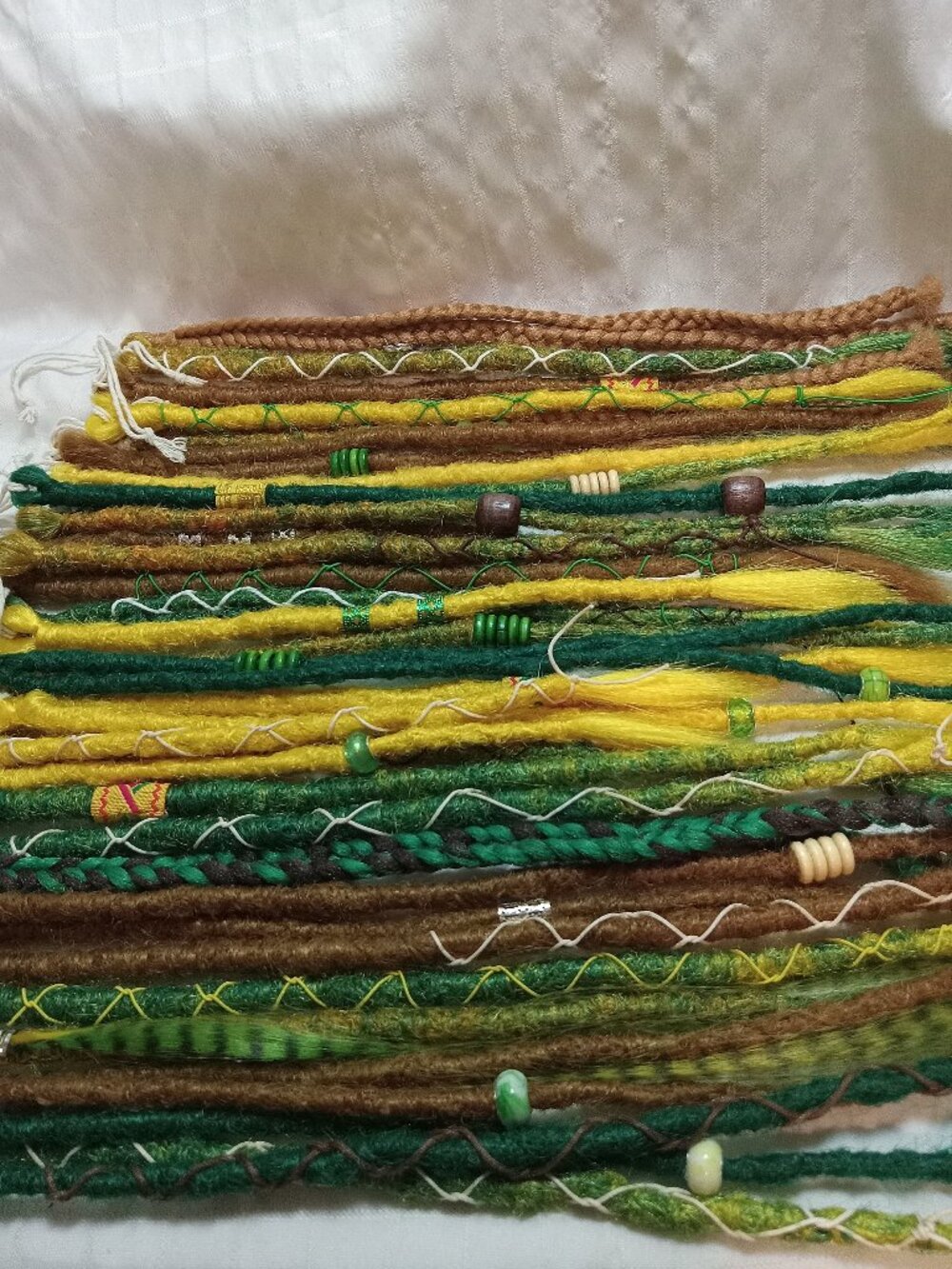 A full head of dreadlocks and braids, handmade from soft synthetic materials